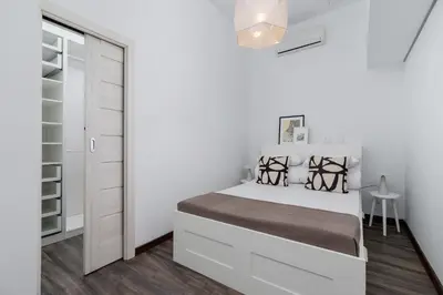 a white bedroom with a bed and a closet at 3 Bedroom Apartment - Rynek Podgórski 15 in Kraków
