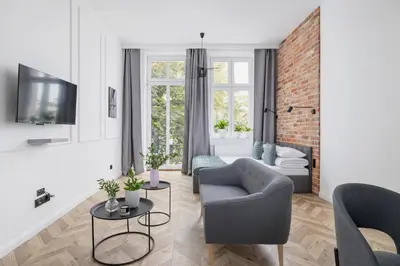 a living room with a couch and a chair at Kazimierz - Apartment with Balcony - Starowiślna 41 in Kraków