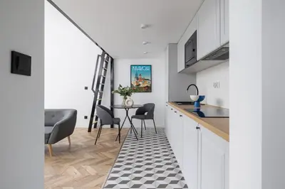 a kitchen with a table and chairs and a staircase at Kazimierz - Apartment with Balcony - Starowiślna 41 in Kraków