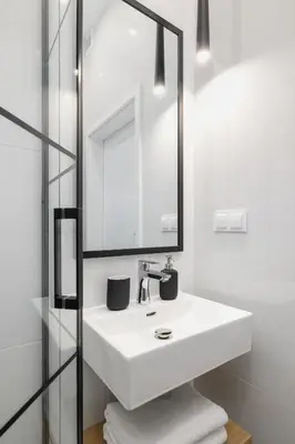 a bathroom with a white sink and a mirror at Kazimierz - Apartment with Balcony - Starowiślna 41 in Kraków