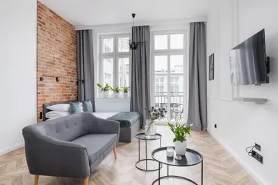 a living room with a couch and a chair at Apartment with Balcony - Kazimierz- Starowiślna 41 in Kraków