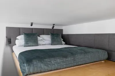 a bedroom with a large bed with a green blanket at Apartment with Balcony - Kazimierz- Starowiślna 41 in Kraków