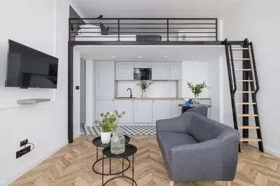 a living room with a chair and a loft bed at Apartment with Balcony - Kazimierz- Starowiślna 41 in Kraków