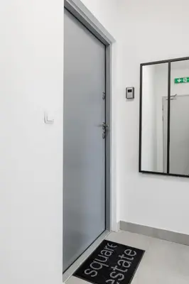 a welcome mat in front of a door with a mirror at Studio with an AC - Kazimierz - Starowislna 41 in Kraków