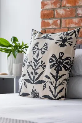 a black and white pillow sitting on a bed at Studio with an AC - Kazimierz - Starowislna 41 in Kraków