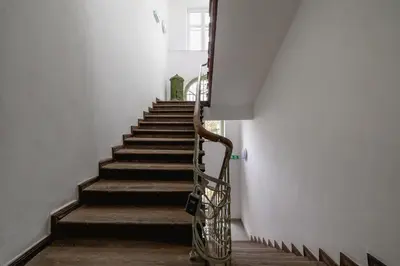 a stairway with a metal handrail and stairs at Studio in Kazimierz District - AC - Starowislna 41 in Kraków