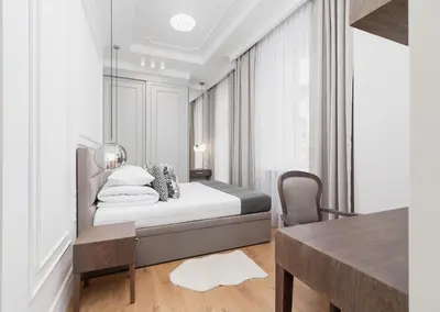 a white bedroom with a bed and a table at 1 bedroom apartment - Kazimierz- Starowislna 43 in Kraków