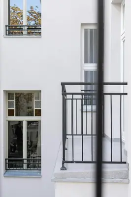 a balcony with a metal railing and two windows at 1 bedroom apartment - Kazimierz- Starowislna 43 in Kraków