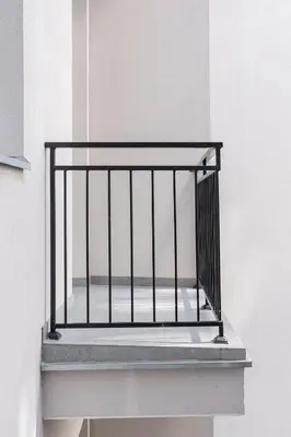 a balcony with a metal railing on a white wall at 1 bedroom apartment - Kazimierz- Starowislna 43 in Kraków