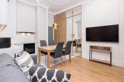 a living room with a couch and a dining room at 1 bedroom apartment - Kazimierz- Starowislna 43 in Kraków