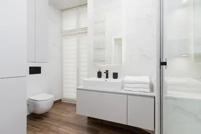 a white bathroom with a sink and a toilet at 1 bedroom apartment - Kazimierz- Starowislna 43 in Kraków