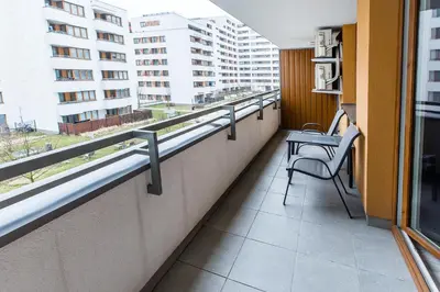 a balcony with a table and chairs in a building at Premium Glamour Apartment by Krakow Home in Kraków