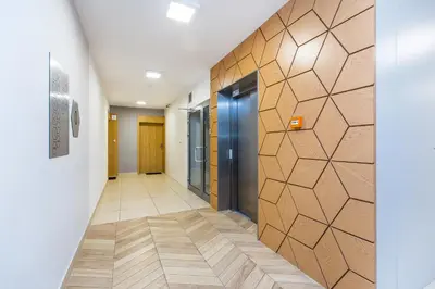 a hallway with a wall of elevators in a building at Premium Glamour Apartment by Krakow Home in Kraków