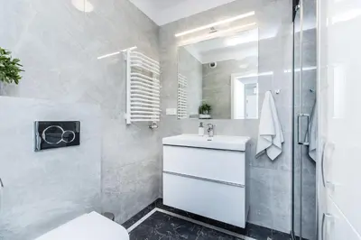 a bathroom with a white sink and a shower at Premium Glamour Apartment by Krakow Home in Kraków