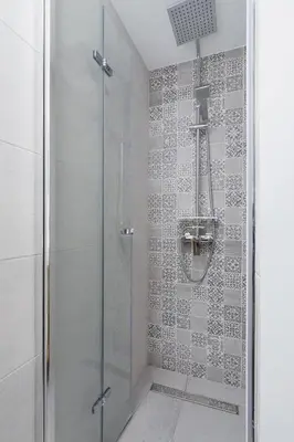 a bathroom with a shower with a glass door at Apartment with mezzanine - Radziwiłłowska 27 in Kraków