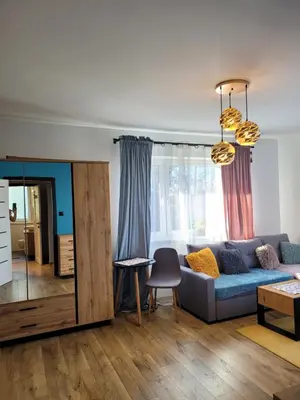 a living room with a couch and a table at Apartamencik Pod Krokusem in Rabka-Zdroj