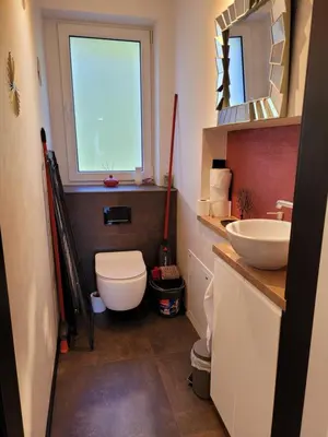 a bathroom with a toilet and a sink and a window at Apartamencik Pod Krokusem in Rabka-Zdroj