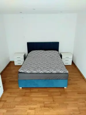a bedroom with a bed and two night stands at House in Zabierzów in Zabierzów