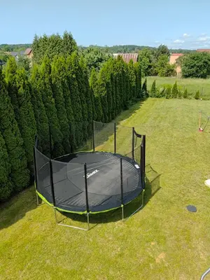 a trampoline in the grass in a yard at House in Zabierzów in Zabierzów