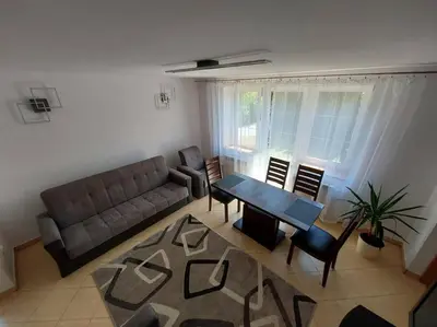 a living room with a couch and a table and chairs at House in Zabierzów in Zabierzów