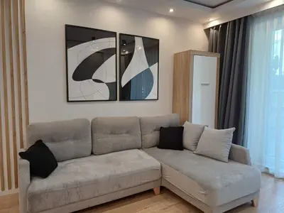 a living room with a couch in a room at Place4You in Kraków