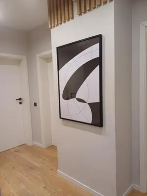 a painting hanging on a wall in a room at Place4You in Kraków