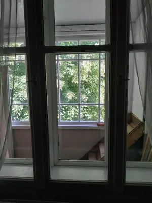 an open window in a room with trees outside at Dom pod Galazka in Bochnia