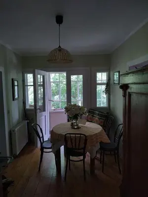 a dining room with a table with chairs and a couch at Dom pod Galazka in Bochnia