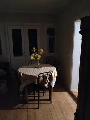 a dining room table with a vase of flowers on it at Dom pod Galazka in Bochnia