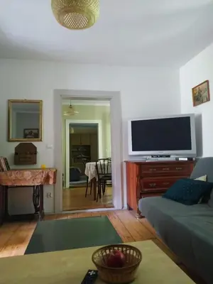 a living room with a couch and a flat screen tv at Dom pod Galazka in Bochnia