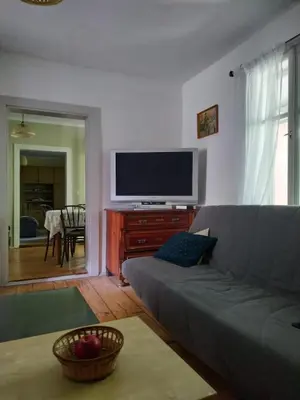 a living room with a couch and a flat screen tv at Dom pod Galazka in Bochnia