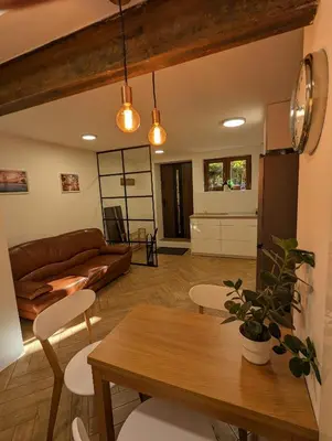 a living room with a table and a couch at Highstreet in Kraków
