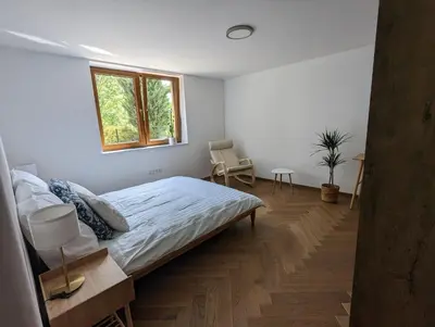 a white bedroom with a bed and a window at Highstreet in Kraków