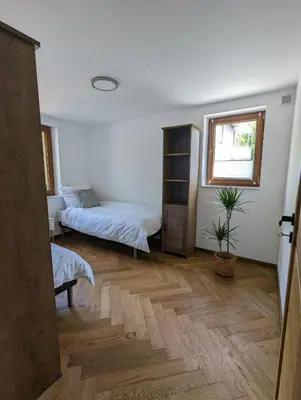 a room with two beds and a window at Highstreet in Kraków