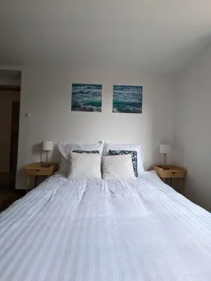 a bedroom with a white bed with two tables at Highstreet in Kraków