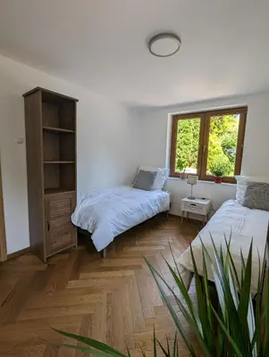 a bedroom with two beds and a window at Highstreet in Kraków