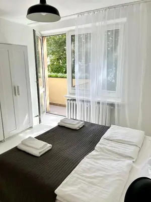 a bedroom with a large bed with two towels on it at Tomasza Street Main Square Apartment in Kraków