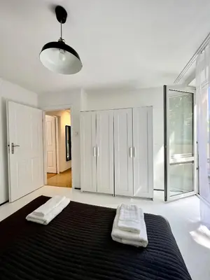 a bedroom with a large bed with two towels on it at Tomasza Street Main Square Apartment in Kraków