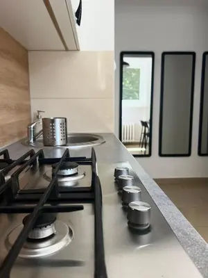 a kitchen with a stove top in a kitchen at Tomasza Street Main Square Apartment in Kraków