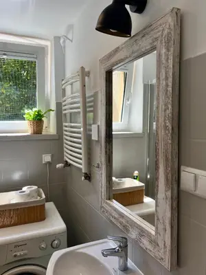 a bathroom with a mirror and a sink at Tomasza Street Main Square Apartment in Kraków