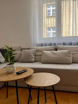 a living room with a couch and a table at Tomasza Street Main Square Apartment in Kraków