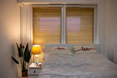a bedroom with a white bed with a window at Imperial Citi Yes Apartament in Kraków