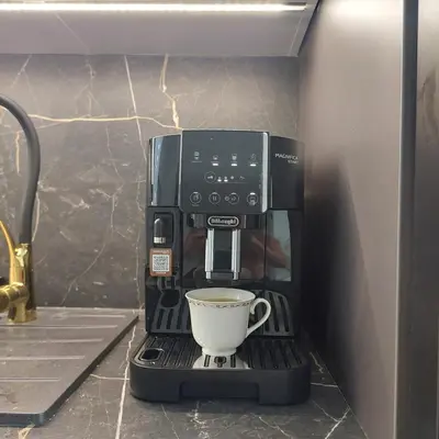 a coffee maker with a cup on a stand at Imperial Citi Yes Apartament in Kraków