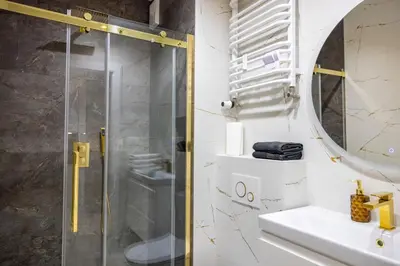 a bathroom with a shower and a sink at Imperial Citi Yes Apartament in Kraków