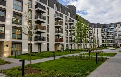 an apartment building with a park in front of it at Imperial Citi Yes Apartament in Kraków