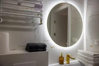 a bathroom with a mirror and a sink at Imperial Citi Yes Apartament in Kraków