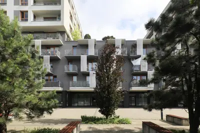an apartment building with trees in front of it at Luxury Apartment Zablocie WiFi Air Conditioning in Kraków