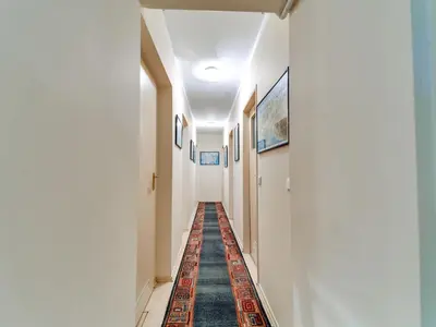 a hallway with a rug on the floor of a building at Apartment Marcyporęba by Interhome in Marcyporęba