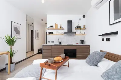 a living room with a white couch and a table at Studio apartment - Rakowicka 14 Street in Kraków