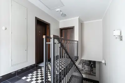 a hallway with a black and white checkered floor at Studio apartment - Rakowicka 14 Street in Kraków